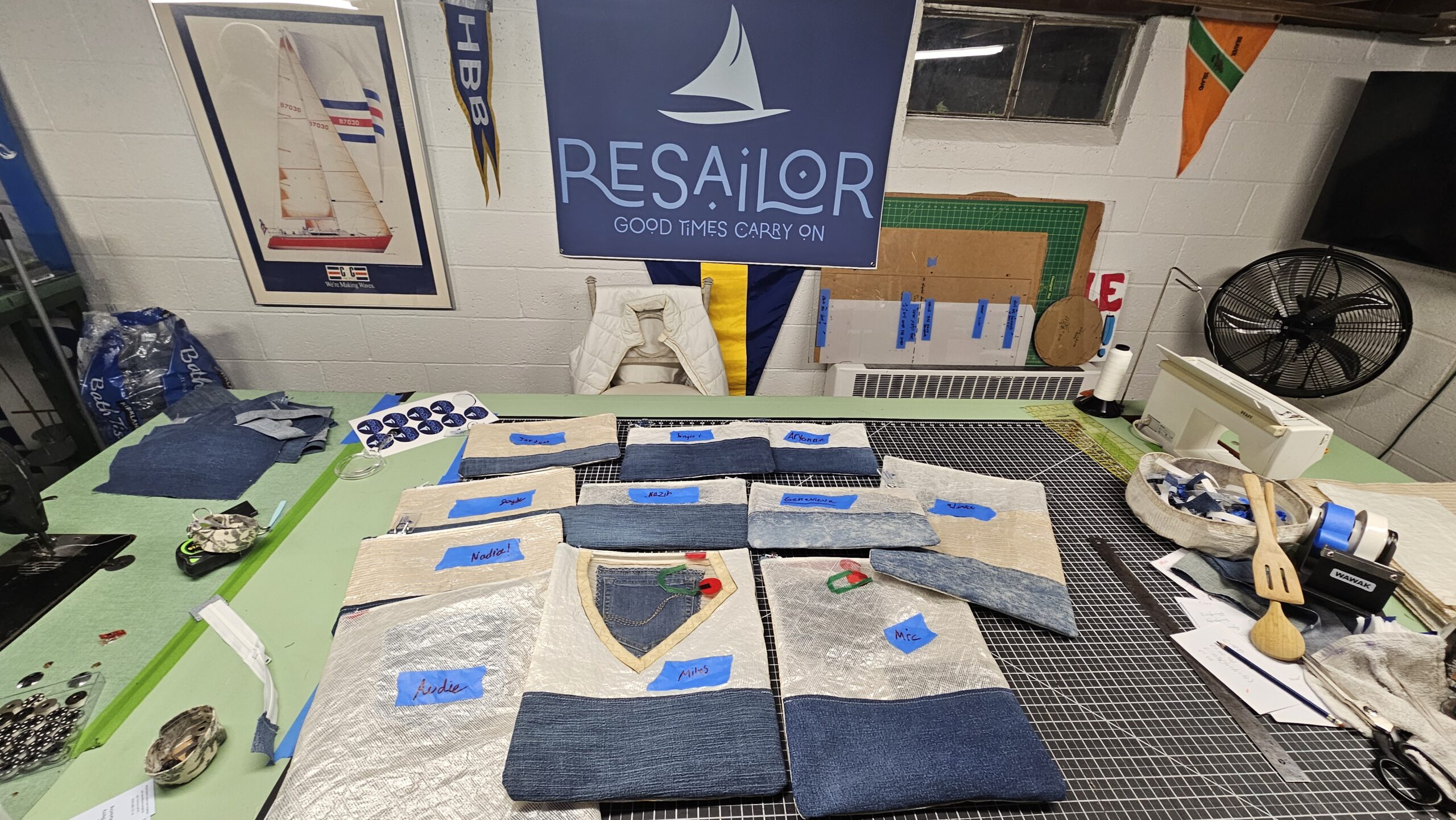 Handmade knitwear items with nautical designs displayed on a table.