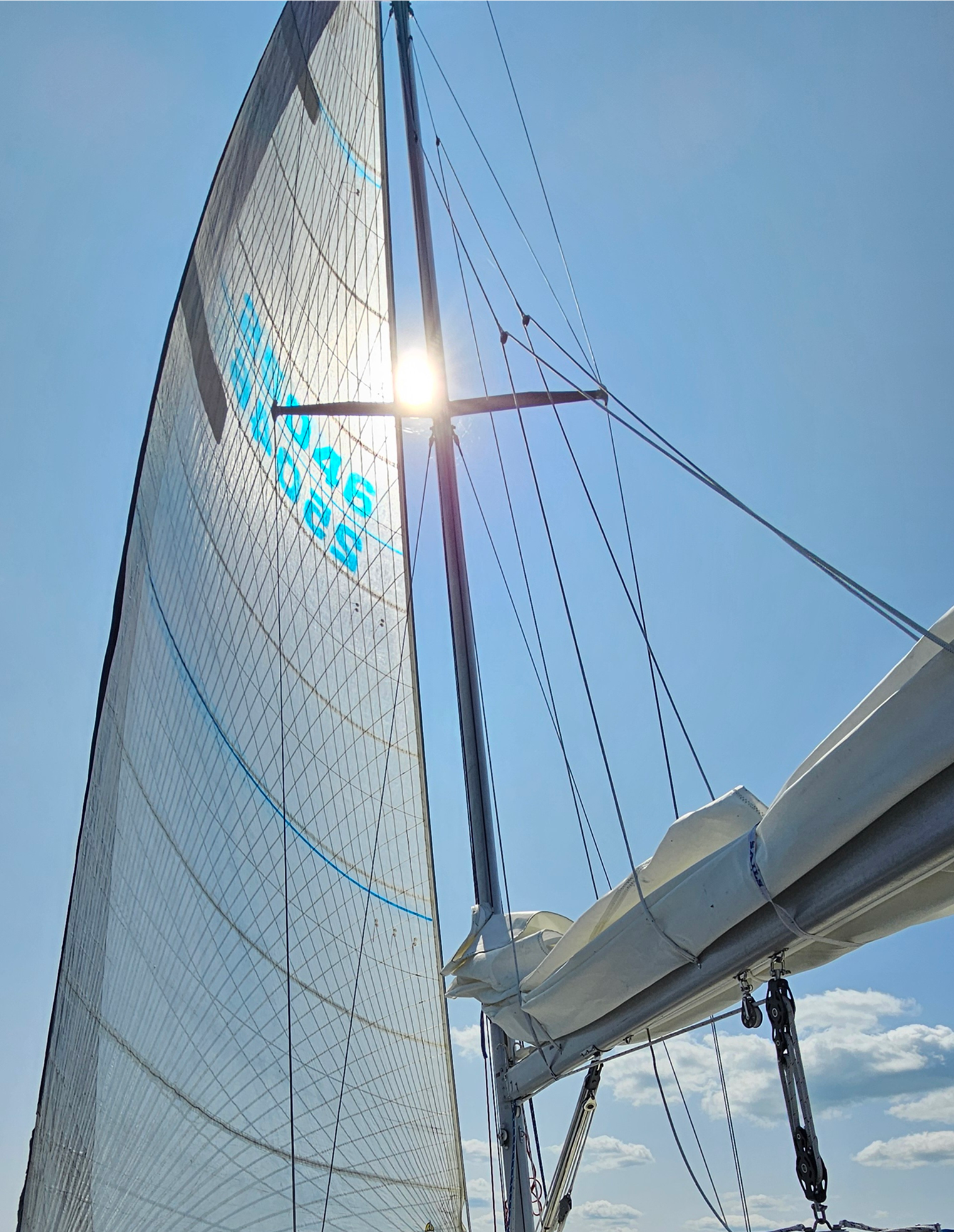 Sailboat mast against blue sky